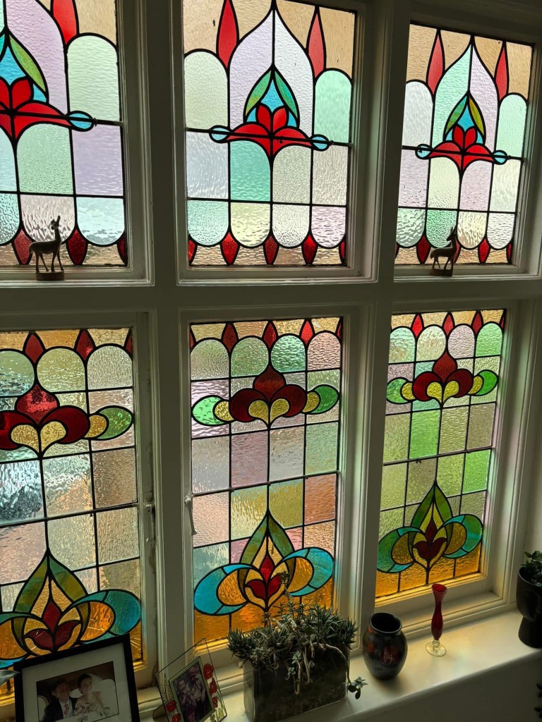Stained glass window with decorative leaded panels
