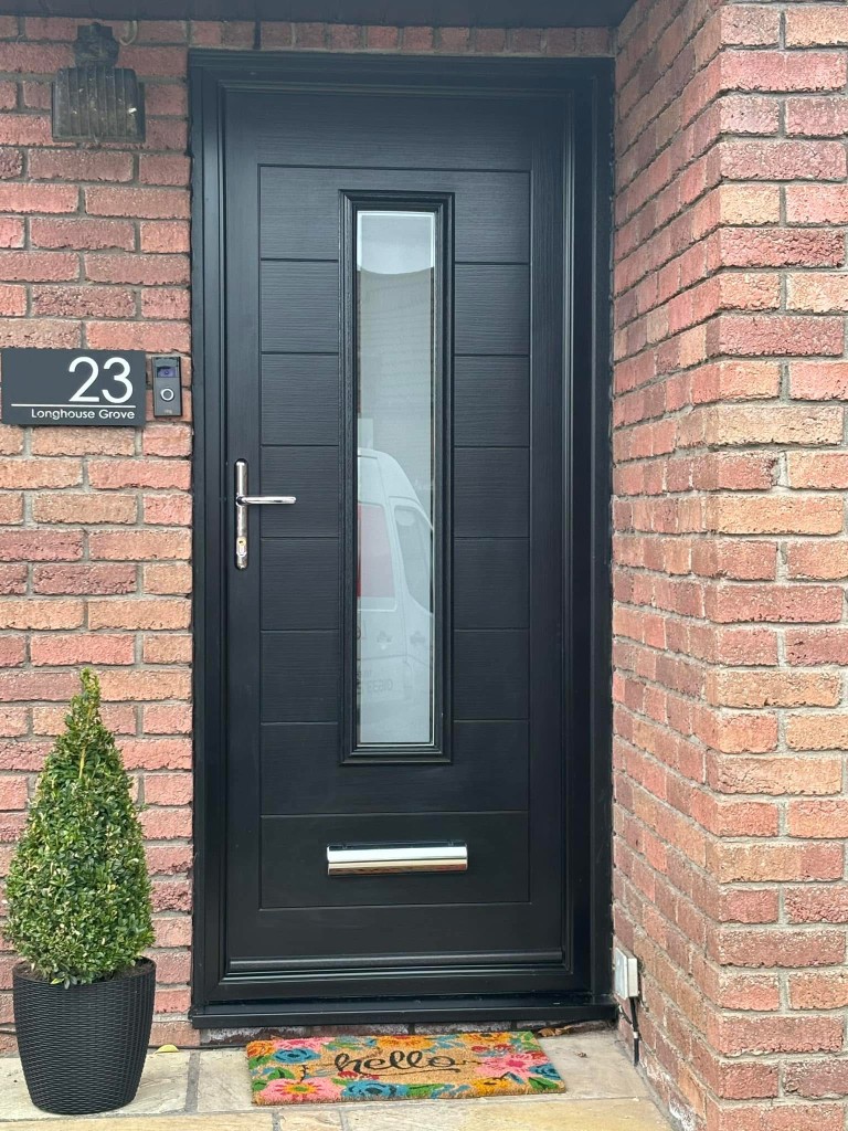 Black composite door with horizontal panels and frosted glass