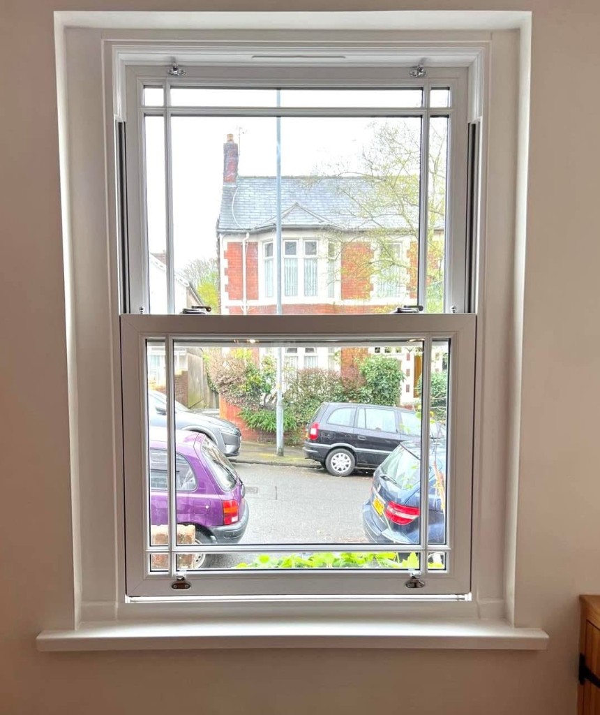 Interior view of white uPVC sash window with street view