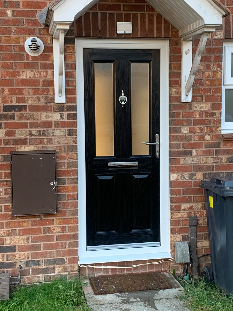 White uPVC front door with side panels