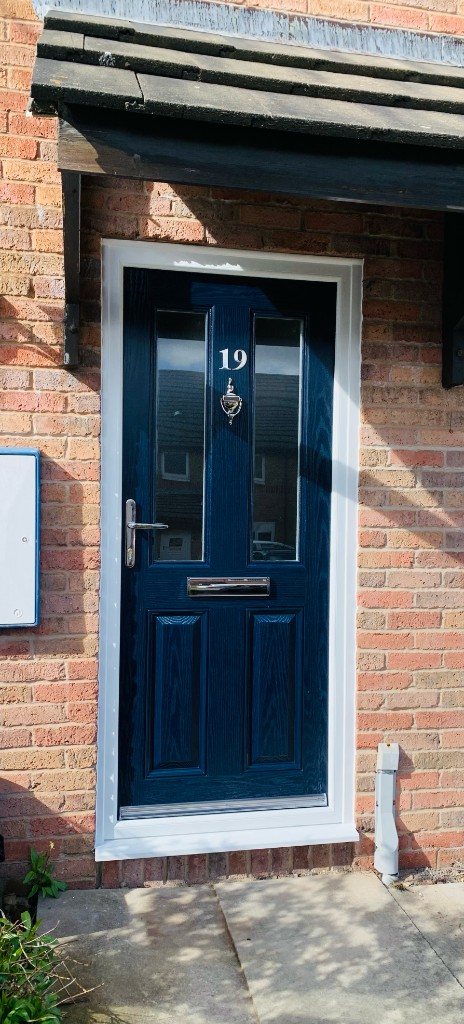White bi-fold doors on brick extension