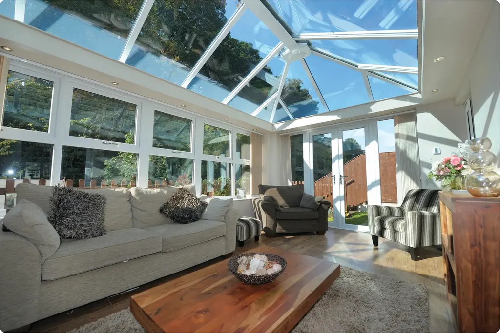 Conservatory living room with glass roof and garden views
