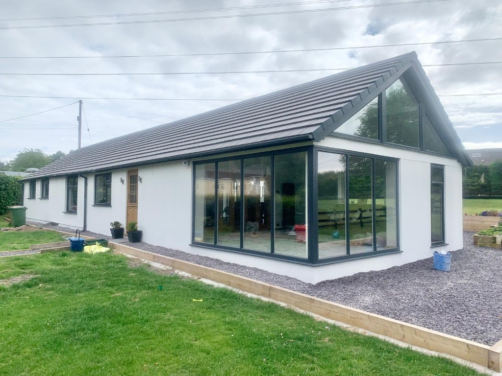 Modern extension with corner glass and gable windows