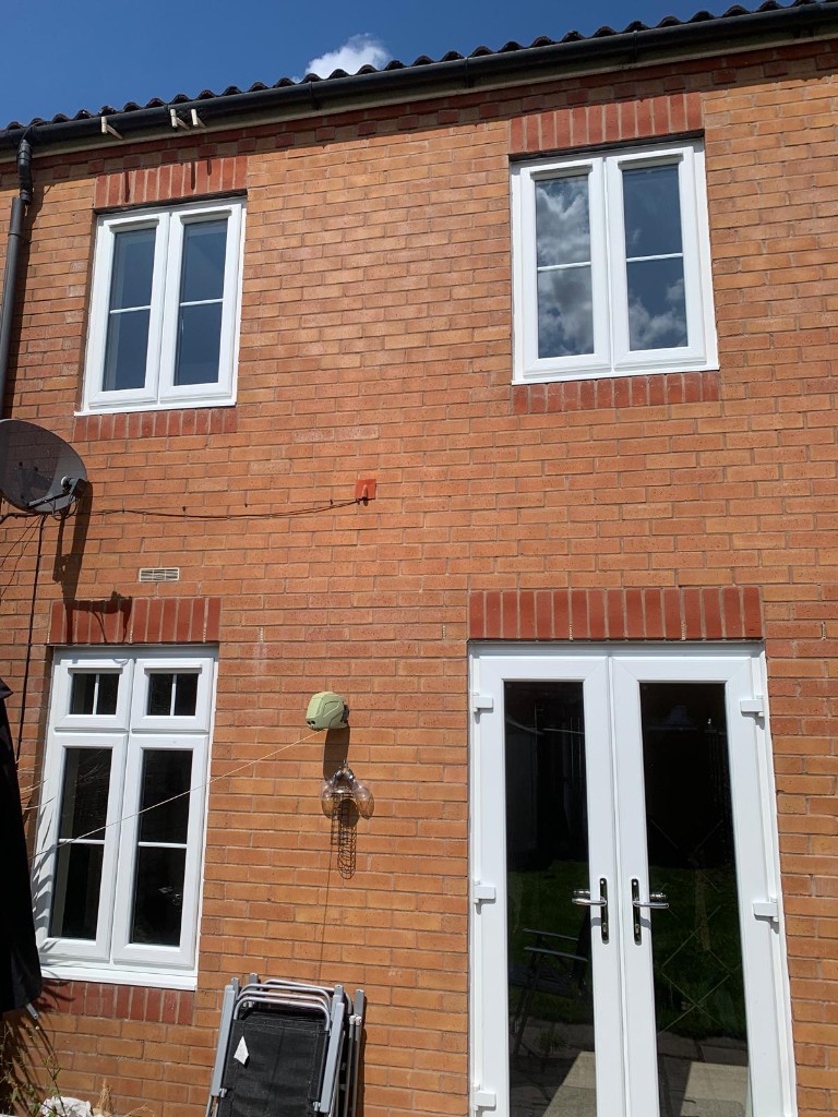White uPVC windows and French doors on brick