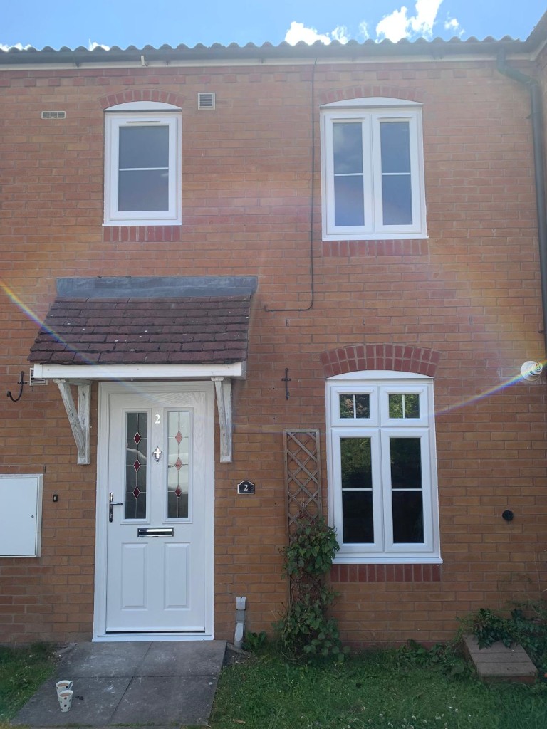 Red brick house with white uPVC windows and composite door